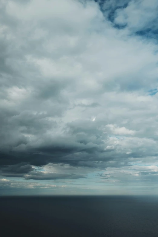 a large body of water under a cloudy sky, inspired by Andreas Gursky, unsplash, blue gray, seaview, today\'s featured photograph 4k, cumulus