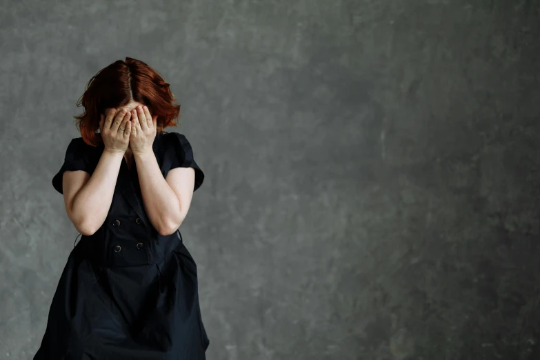 a woman covers her face with her hands, pexels, renaissance, young redhead girl in motion, crying and weeping, hugging her knees, portrait photo of a backdrop