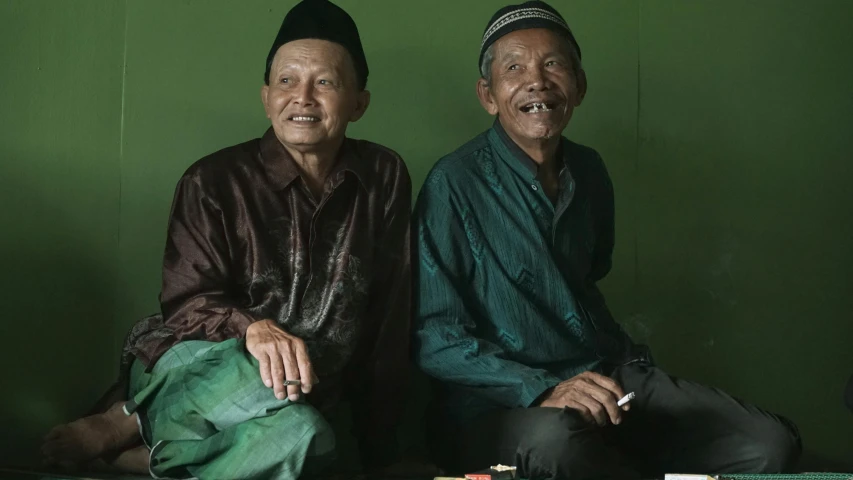 a couple of men sitting next to each other, a portrait, pexels contest winner, sumatraism, slide show, portrait image