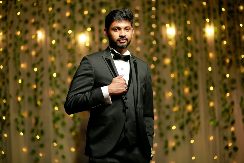 a man in a tuxedo posing for a picture, inspired by Thota Vaikuntham, pexels contest winner, hurufiyya, bokeh backdrop, dramatic lighting; 4k 8k, fan favorite, formal wear