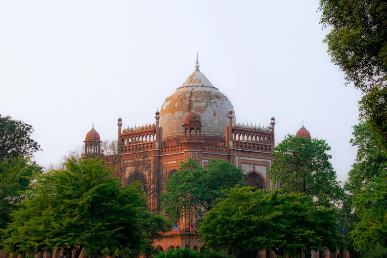 a large building sitting on top of a lush green field, pexels contest winner, art nouveau, beautiful futuristic new delhi, tomb, brown, pink marble building