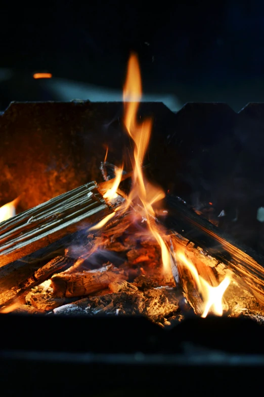 a grill with a bunch of sticks sticking out of it, an album cover, unsplash, roaring fire, up-close, blacksmith, fire and ice