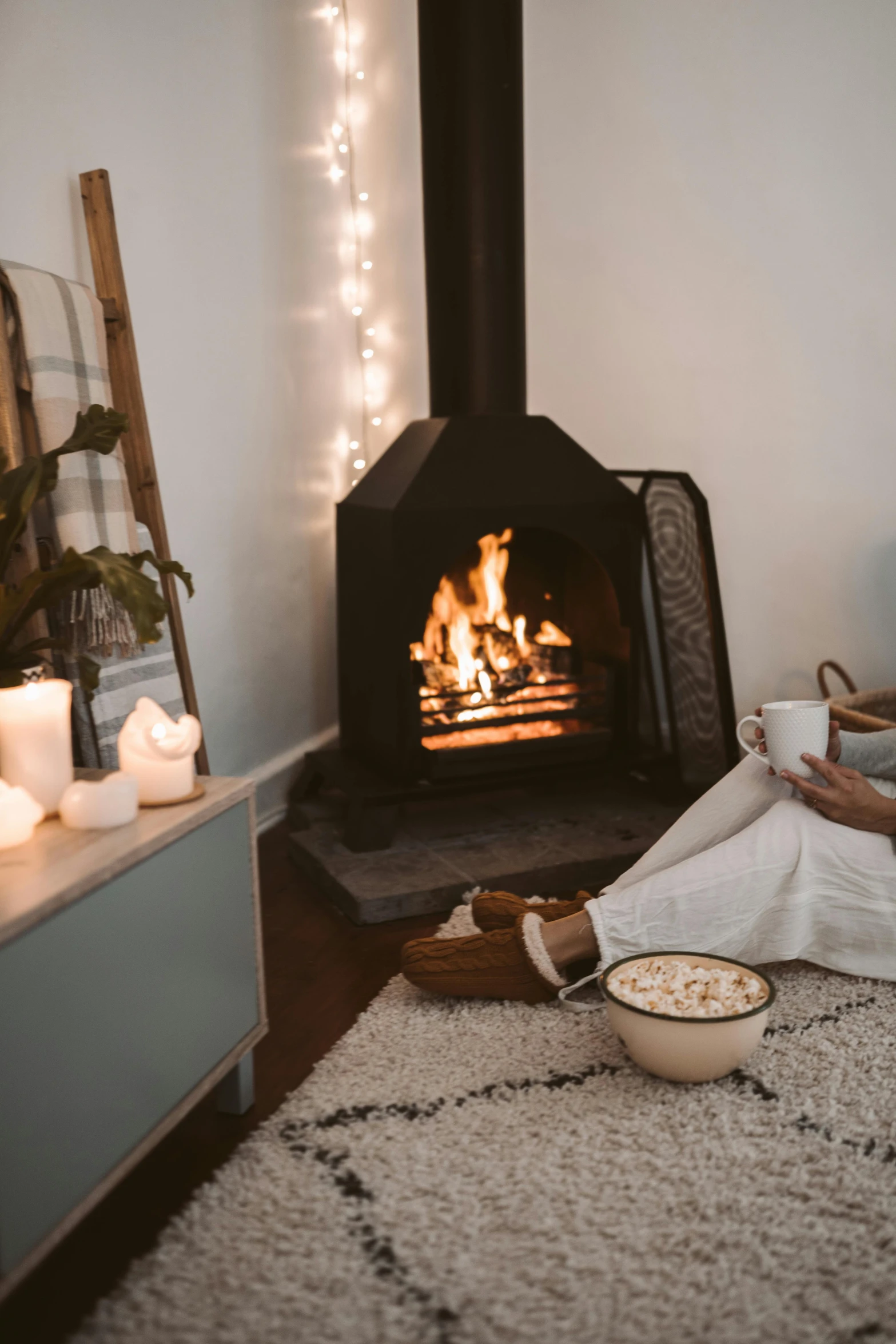 a woman reading a book in front of a fireplace, unsplash contest winner, manuka, marshmallows, cozy room, profile image