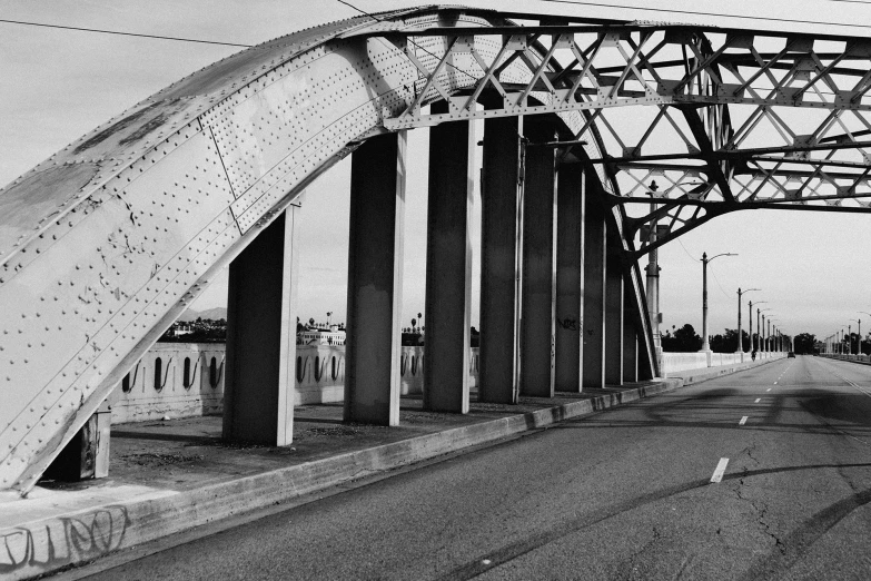 a black and white photo of a bridge, a black and white photo, op art, empty streetscapes, rusty, medium format, high arches