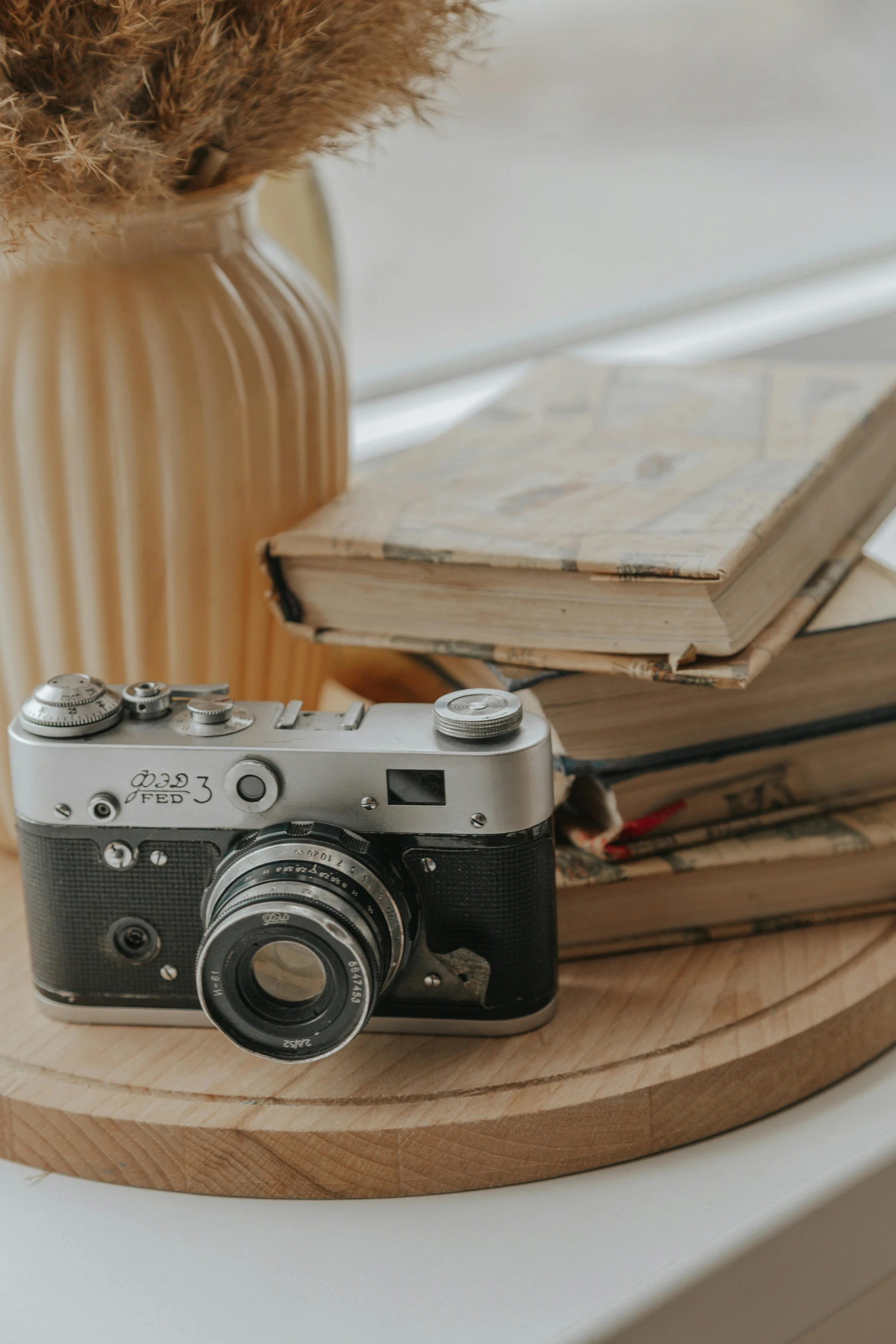 a camera and some books on a table, a picture, by Andries Stock, unsplash contest winner, vintage closeup photograph, today\'s featured photograph 4k, modeling photography, 2022 photograph