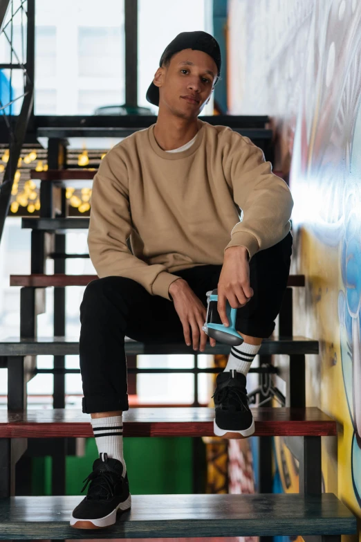 a man sitting on a bench with a skateboard, trending on pexels, lyco art, brown sweater, standing on a shelf, thawan duchanee, confident stance