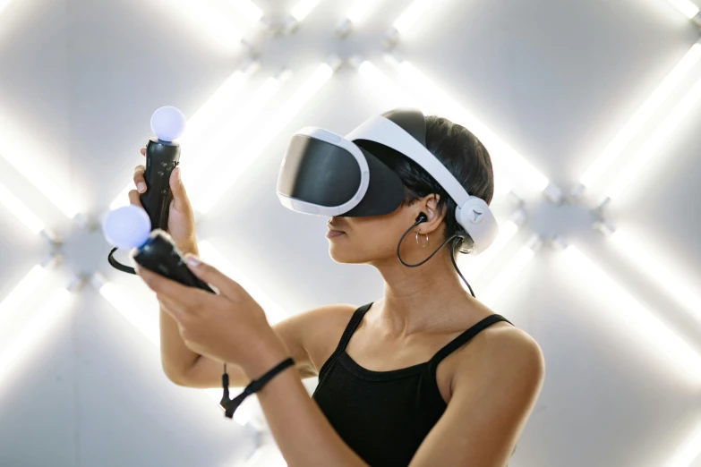 a woman in a black tank top holding a video game controller, inspired by Évariste Vital Luminais, interactive art, 3 d goggles, playstation 5, wearing a gaming headset, shot from below