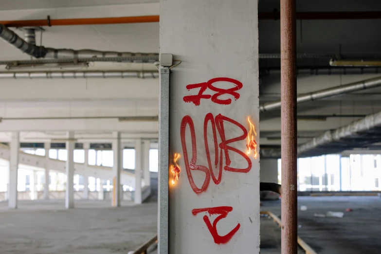 a close up of graffiti on the side of a building, by Kees Bol, unsplash, graffiti, interior of a loft, red and white neon, floor b2, on a parking lot