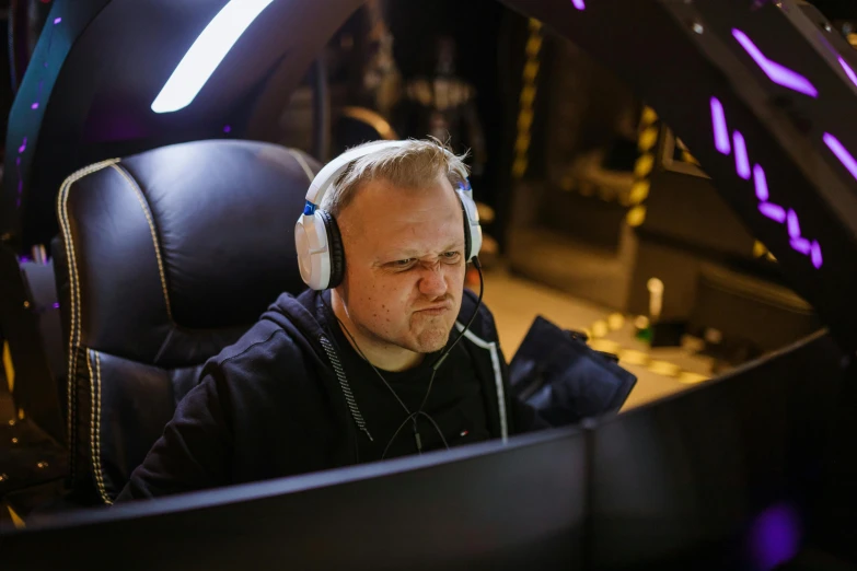 a man sitting in a car wearing headphones, by Adam Marczyński, hurufiyya, wearing a gaming headset, in front of a computer, avatar image, candid shot