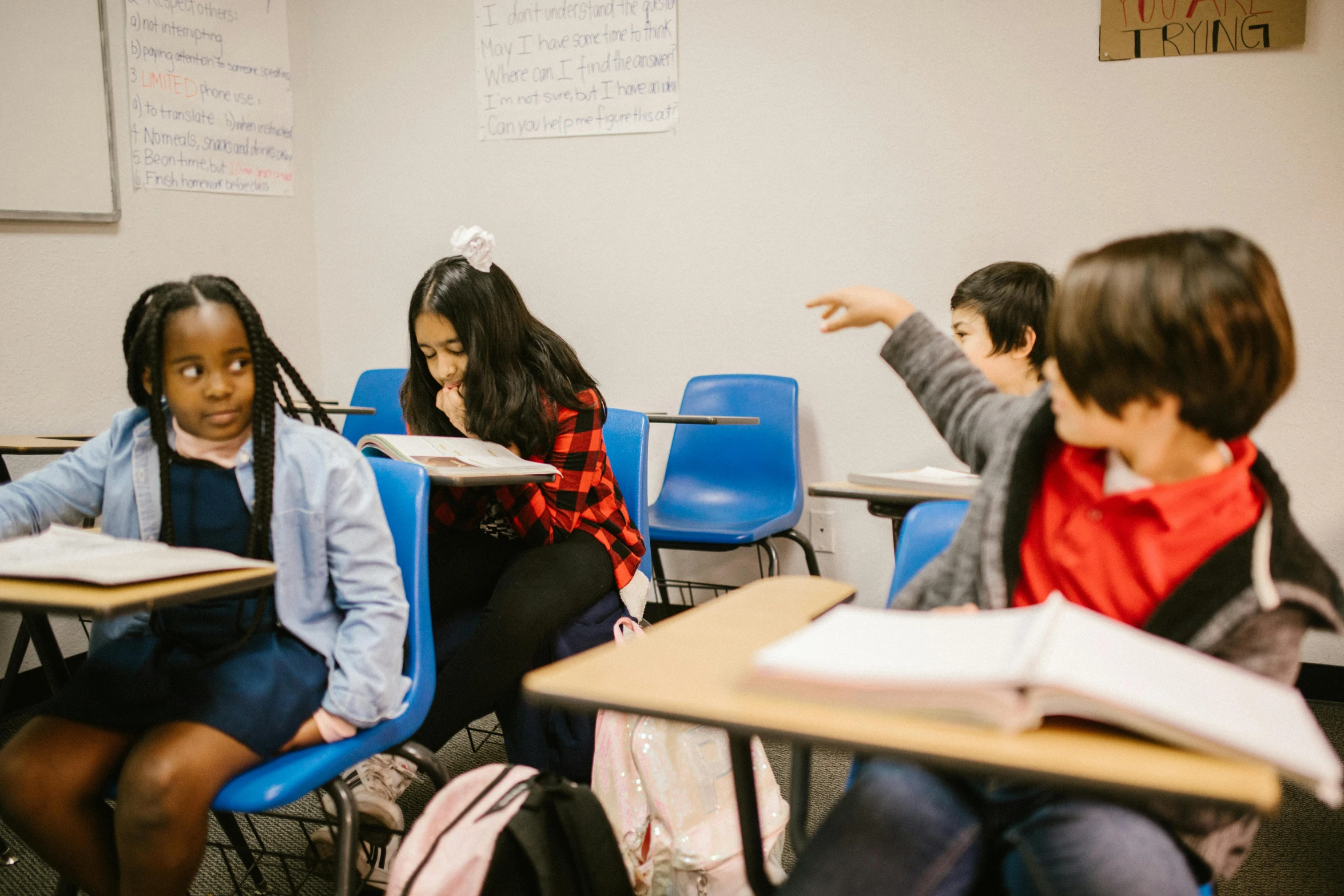 a group of children sitting at desks in a classroom, trending on unsplash, ashcan school, fan favorite, diverse, wide shot photo, studying