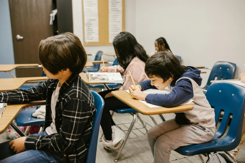 a group of children sitting at desks in a classroom, by Emma Andijewska, pexels contest winner, vancouver school, background image, full body image, thumbnail, 15081959 21121991 01012000 4k