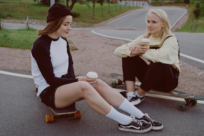 a couple of women sitting on top of a skateboard, trending on pexels, realism, coffee, very very very pale skin, wearing black shorts, 15081959 21121991 01012000 4k