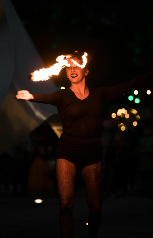 a woman with fire sticks in her hands, pexels, kinetic art, roaming entertainers, teal lights, square, b - roll