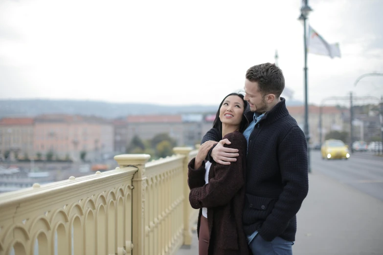 a man and woman standing next to each other on a bridge, happening, budapest street background, avatar image, professional image, thumbnail