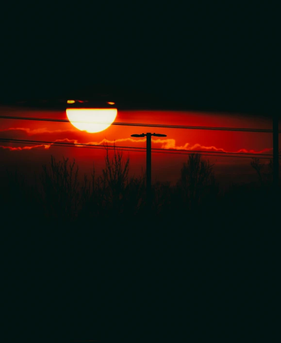 the sun is setting behind a fence, an album cover, pexels contest winner, red light, sweet night ambient, ((sunset)), lo-fi