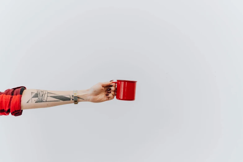 a person holding a red cup in their hand, a tattoo, by Romain brook, pexels contest winner, minimalism, with a white background, morning time, high quality upload, rectangle