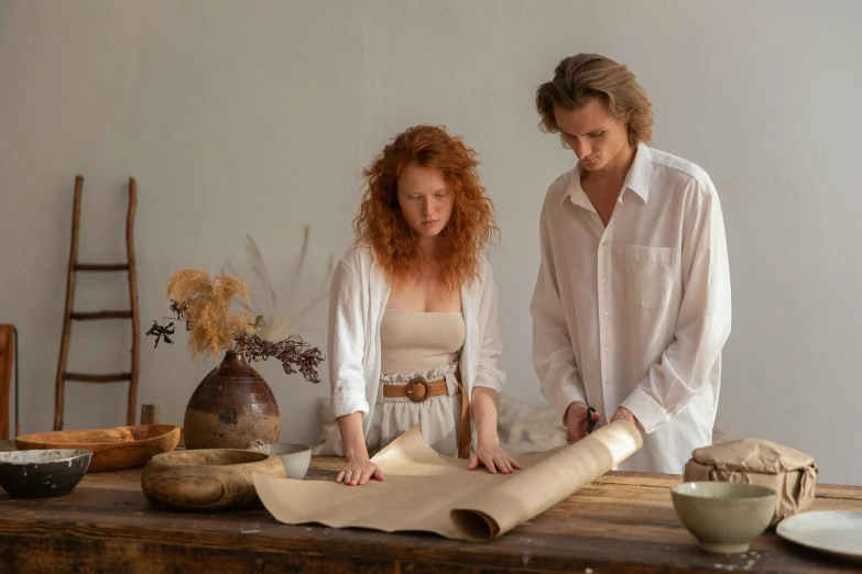 a couple of people that are standing around a table, pexels contest winner, renaissance, wearing a linen shirt, clay material, long flowing fabric, botanical