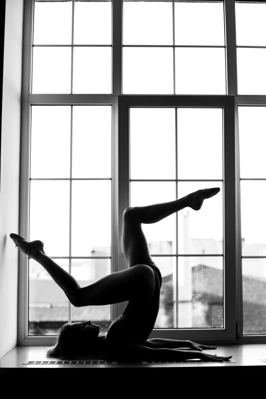 a woman doing a yoga pose in front of a window, by Zsolt Bodoni, arabesque, monochrome!!!!!, nikolay, very perfect position, by :5 sexy: 7