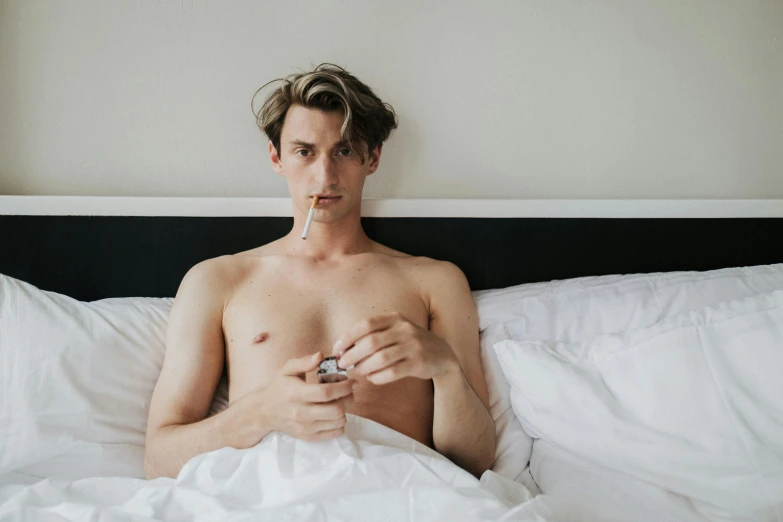 a man laying in bed with a cigarette in his mouth, by Jessie Alexandra Dick, trending on pexels, long trunk holding a wand, skinny caucasian young man, caspar james gurney, heath clifford