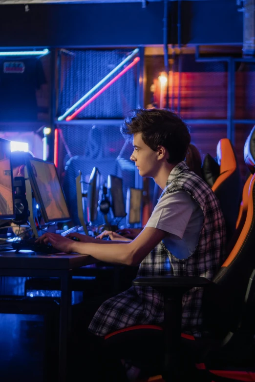 a man sitting at a desk in front of a computer, inspired by John Luke, gamer themed, still from a movie, high school, server in the middle