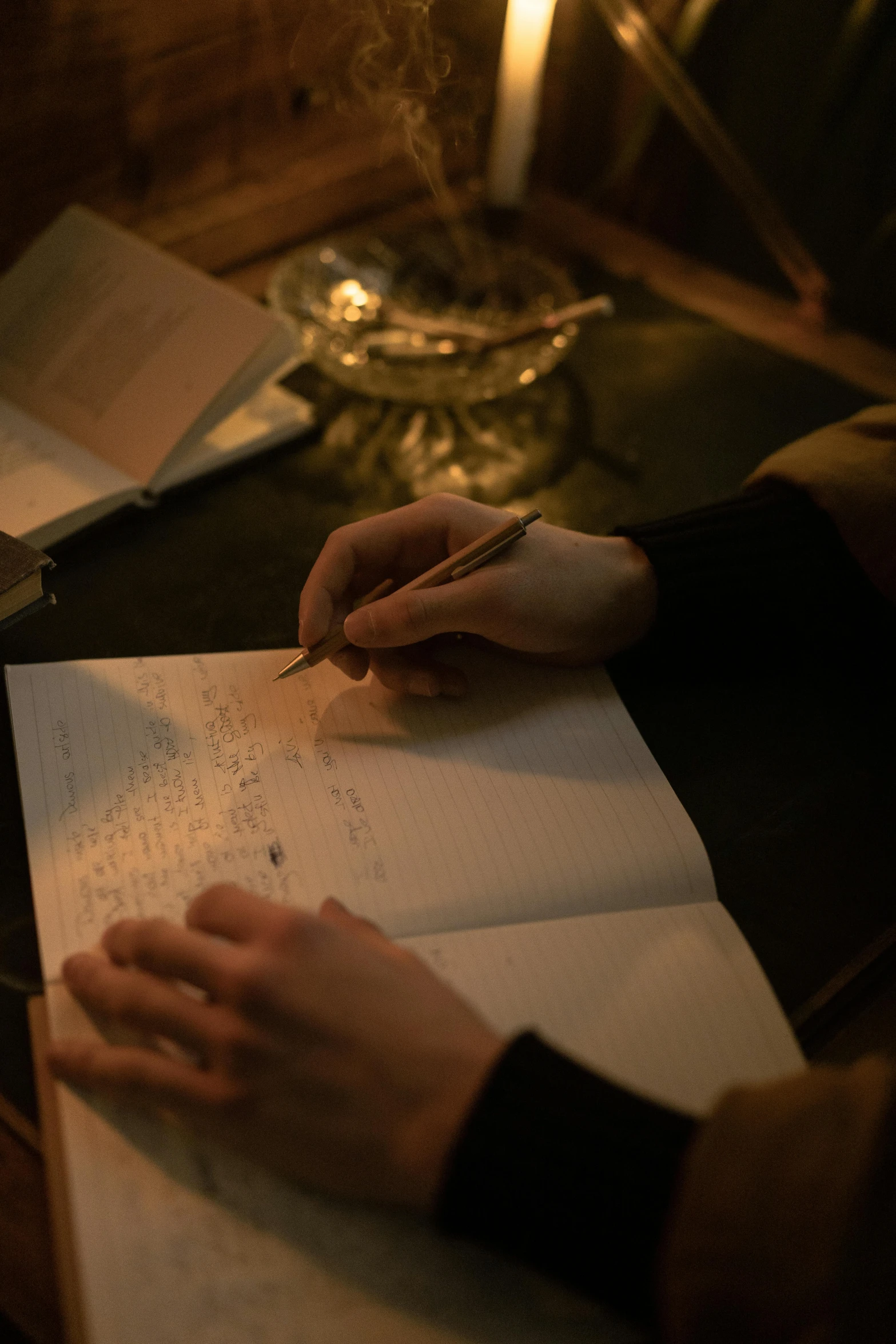 a person sitting at a table writing on a piece of paper, romanticism, in a dark, cosy, collaboration, middle shot