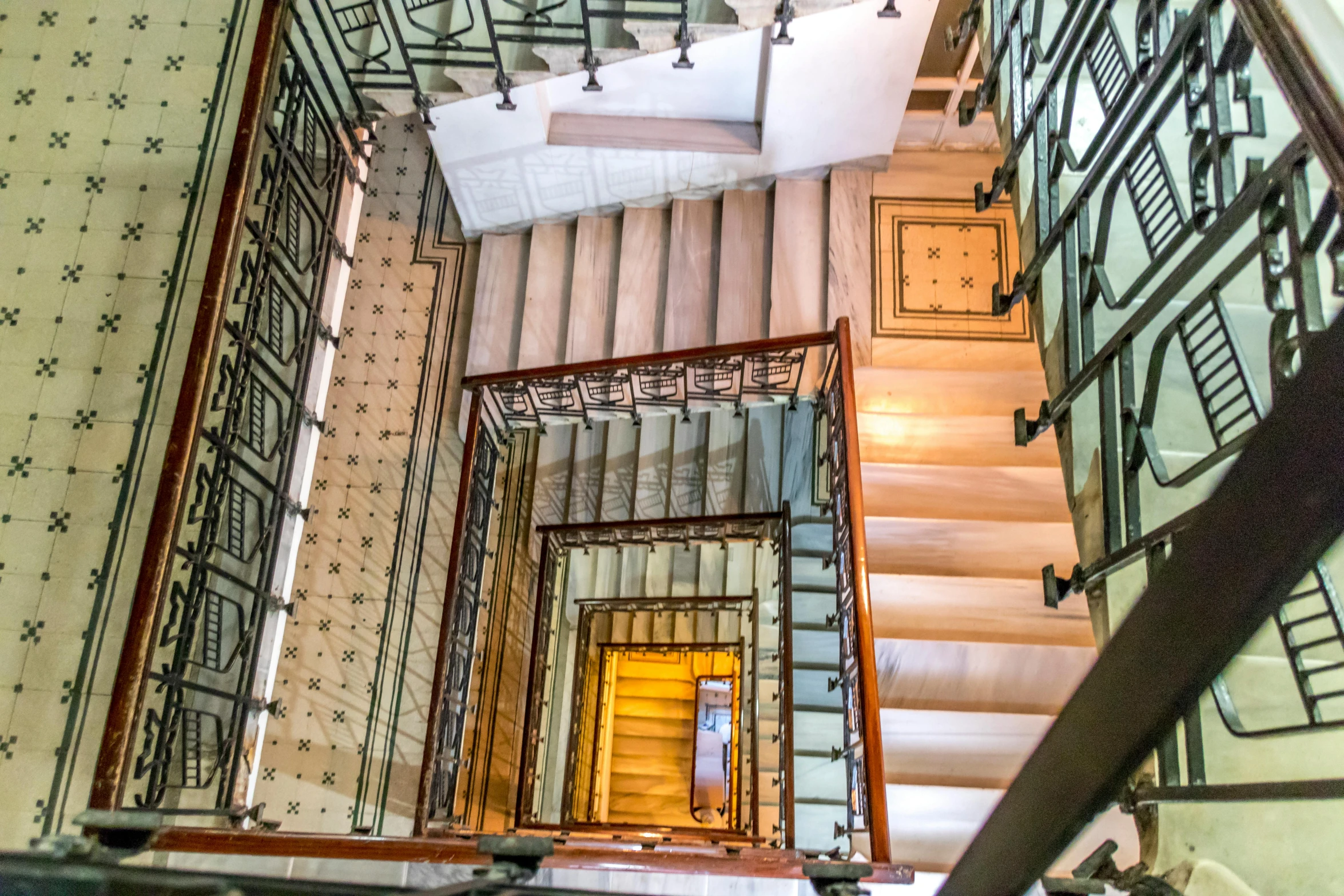 a view from the top of a set of stairs, inspired by Rodolfo Escalera, pexels contest winner, art nouveau, square, thumbnail, brown, multi - level