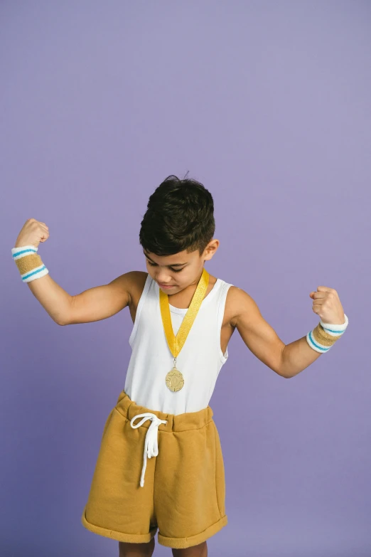 a little boy standing on top of a skateboard, an album cover, pexels contest winner, symbolism, showing off biceps, gold medal, bracelets, rebecca sugar