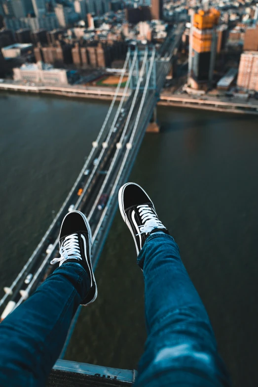 a person standing on top of a bridge, legs taking your pov, trending on r/streetwear, brooklyn background, helicopter view