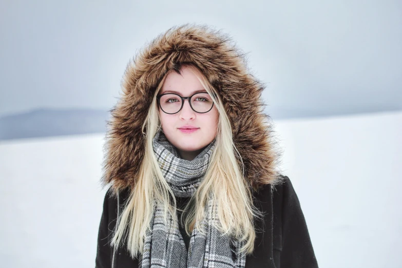 a woman wearing glasses and a scarf standing in the snow, inspired by Louisa Matthíasdóttir, pexels contest winner, blond furr, reykjavik junior college, avatar image, square rimmed glasses