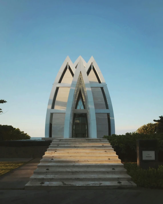 a large white building sitting in the middle of a park, an art deco sculpture, by Adam Rex, unsplash, ( ( ( kauai ) ) ), ribbon chapel, twin towers, views to the ocean