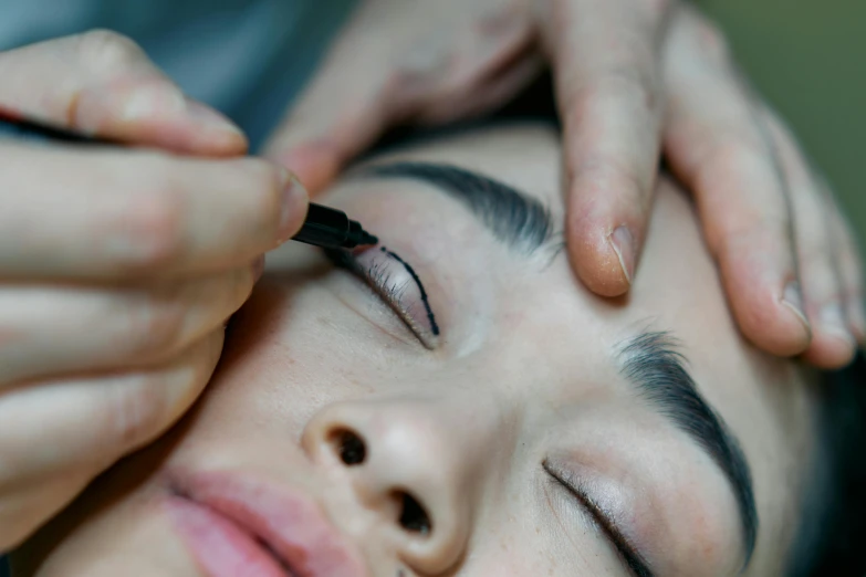 a woman getting her eyebrows done at a beauty salon, a tattoo, trending on pexels, hurufiyya, thumbnail, black eyeliner, ink outline, japanese