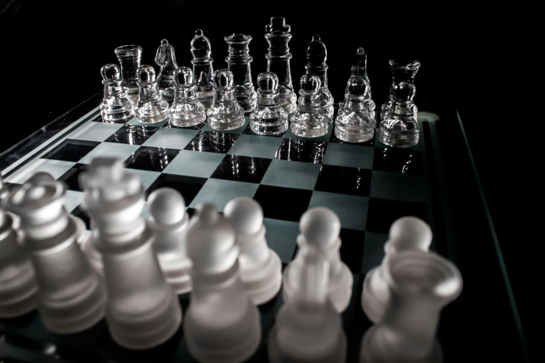 a glass chess board with chess pieces on it, an album cover, by Carey Morris, unsplash, photorealism, on black background, standoff, paul barson, fan favorite