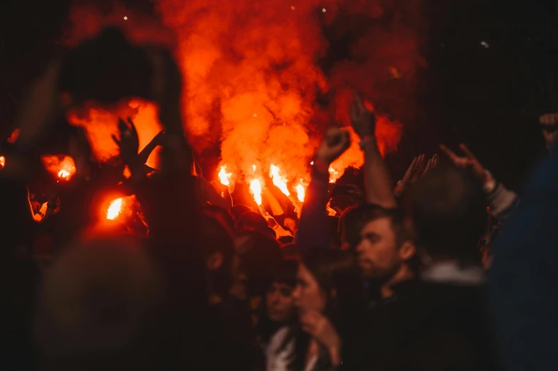 a group of people that are standing in front of a fire, liverpool football club, deep pyro colors, unsplash photo contest winner, very smoky paris bar