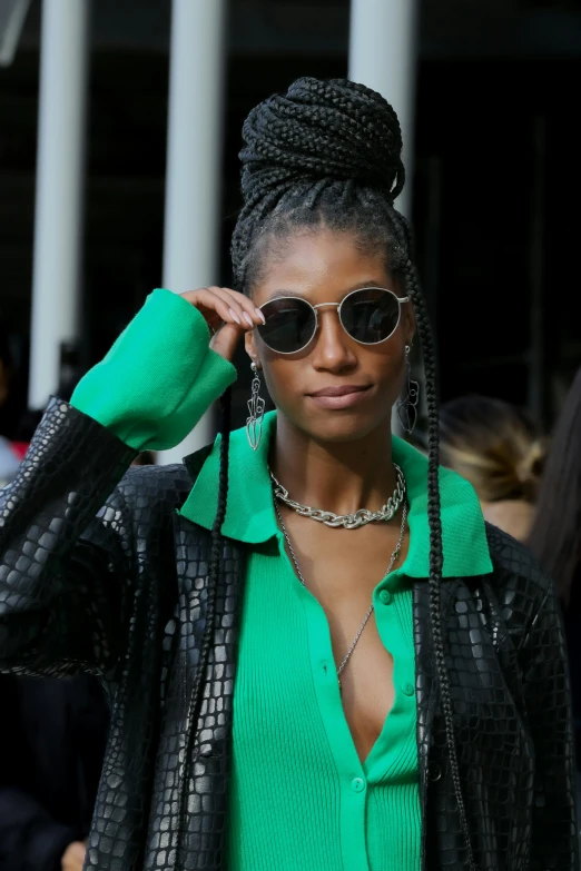 a woman in a green shirt and black jacket, trending on pexels, renaissance, willow smith zendaya, reflective aviator sunglasses, fashion week, video