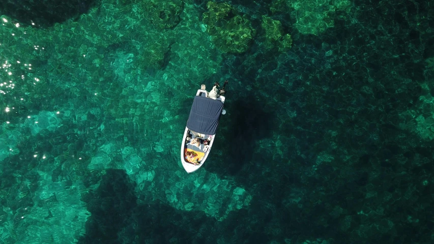 a boat that is floating in the water, by Adam Marczyński, pexels contest winner, hurufiyya, top down, the emerald coast, thumbnail, teaser