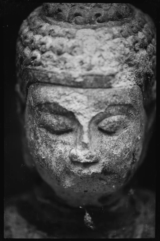 a black and white photo of a statue, inspired by Li Di, unsplash, square face, zen feeling, macro shot head, analogue photo low quality