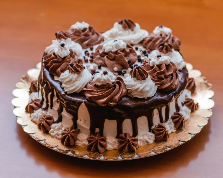 a chocolate cake sitting on top of a wooden table, fully decorated, brown and white color scheme, best selling, thumbnail