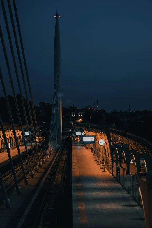 a couple of benches sitting on top of a bridge, by Adam Szentpétery, pexels contest winner, happening, wires and lights, calm night. over shoulder shot, train station, instagram post