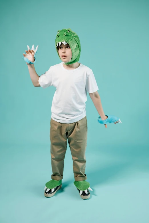 a young boy wearing a dinosaur costume and holding a toothbrush, inspired by Adam Rex, pexels, baggy pants, two legged with clawed feet, stop motion character, press shot