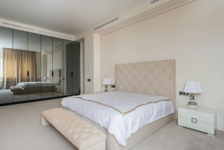 a bed sitting in a bedroom next to a mirror, marbella, thumbnail, city views, beige color scheme