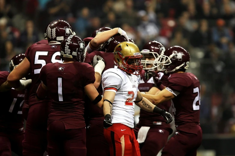 a group of football players standing on top of a field, pexels contest winner, happening, maroon metallic accents, quebec, indoor shot, in 2 0 1 2