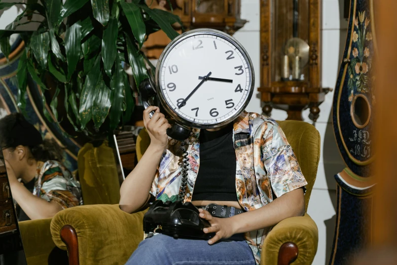 a woman sitting in a chair with a clock on her head, trending on pexels, maximalism, thumbnail, shot on sony a 7, next to a plant, full faced