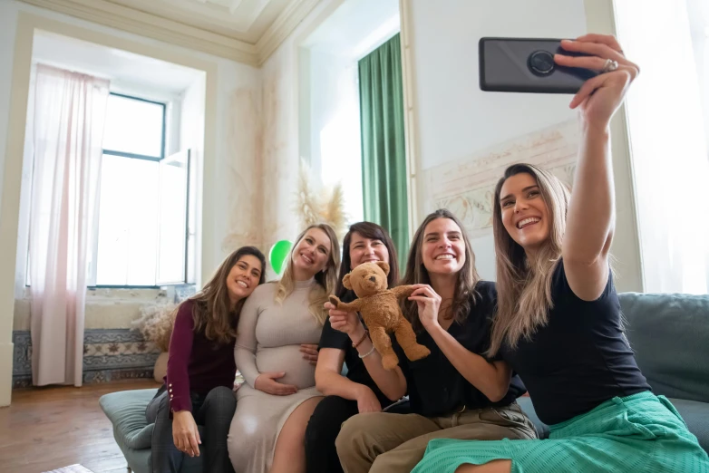 a group of women sitting on top of a couch, a picture, pexels contest winner, pregnant, taking a selfie, avatar image, spanish