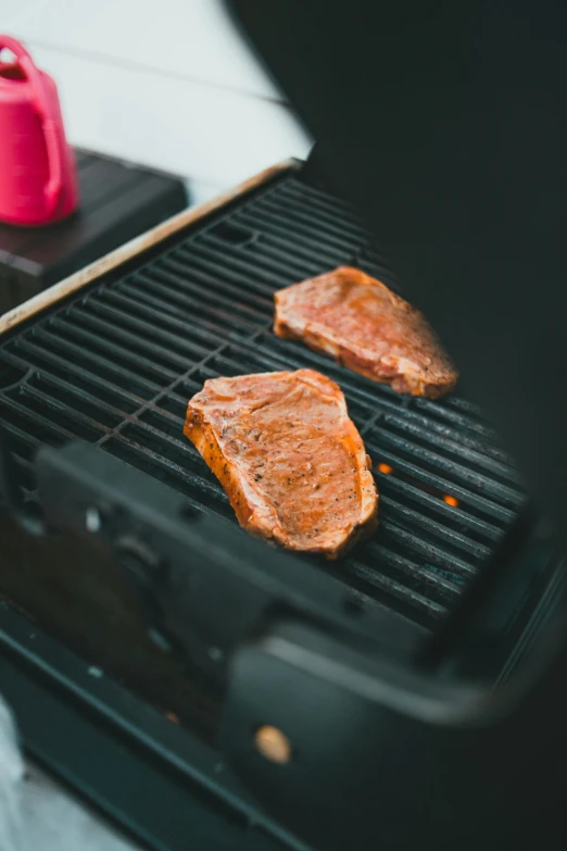 two steaks are being cooked on a grill, by Julia Pishtar, unsplash, square, inspect in inventory image, kek, 33mm photo