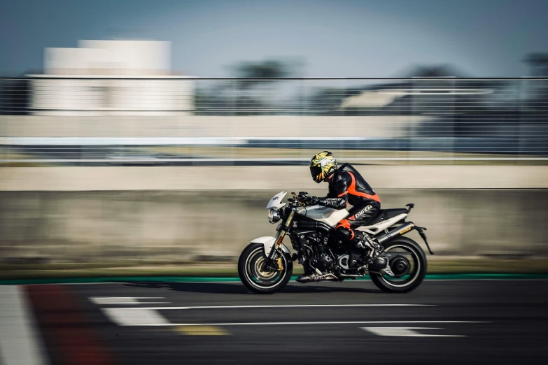 a person riding a motorcycle on a race track, by Daniel Seghers, pexels contest winner, avatar image, france, bulky build, complex background