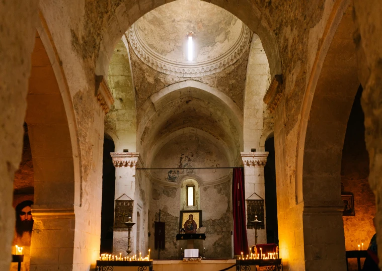 the inside of a church with candles lit up, an album cover, inspired by Taddeo Gaddi, unsplash contest winner, romanesque, apulia, rustic, louis kahn, conde nast traveler photo