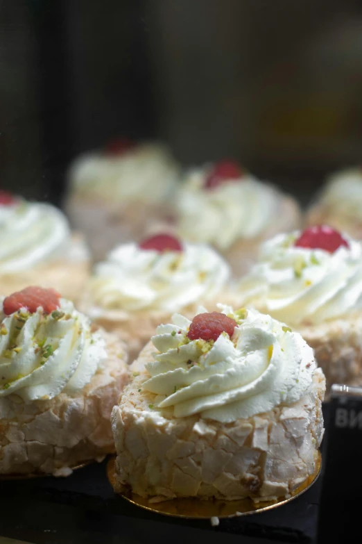 a close up of a tray of pastries on a table, whirling, paul barson, frills, exquisitely detailed