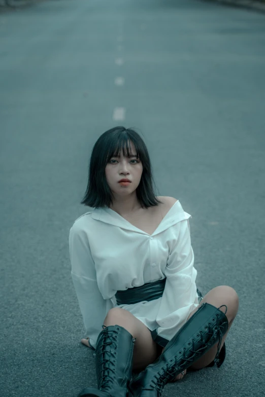 a woman sitting in the middle of a road, an album cover, inspired by Elsa Bleda, pexels contest winner, realism, young asian girl, whitebangs, white shirt, menacing look