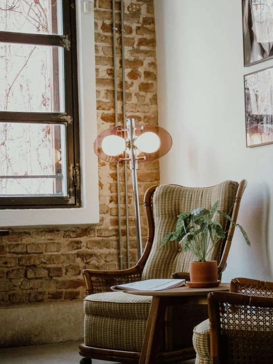 a chair sitting in a living room next to a window, a portrait, pexels contest winner, cafe interior, fan favorite, low quality photo, lamp ( ( ( armchair ) ) ) )