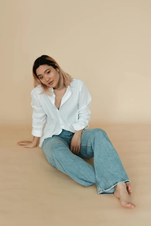 a woman sitting on the floor in a white shirt and jeans, inspired by Ruth Jên, trending on pexels, wearing a linen shirt, kakar cheung, full product shot, pastel'